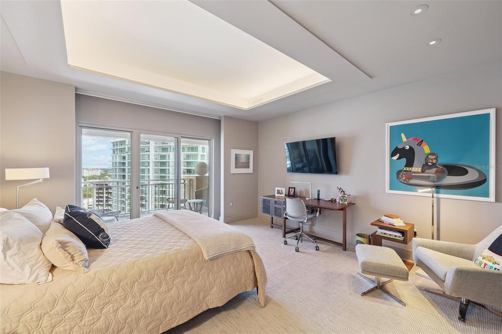 1111 Ritz Carlton Drive, Unit 1704 Sarasota, FL 34236 - Photo 39 of 53 a bedroom with a bed a couch and a flat screen tv