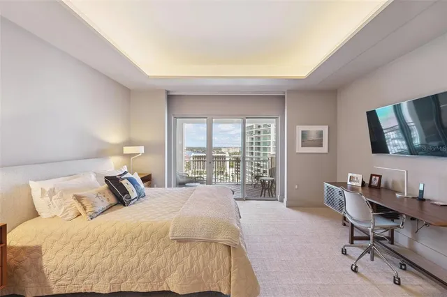 a bedroom with a bed and a large mirror