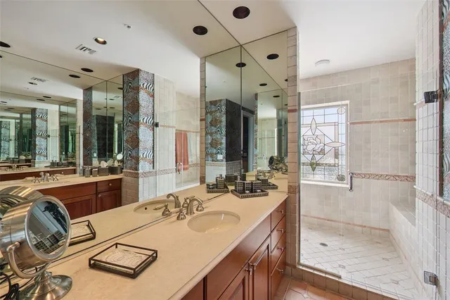 a spacious bathroom with a tub sink and mirror
