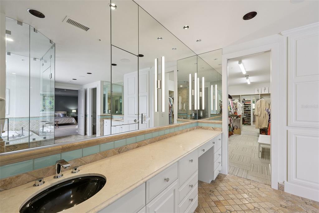 1111 Ritz Carlton Drive, Unit 1704 Sarasota, FL 34236 - Photo 47 of 53 a bathroom with a sink and a large mirror