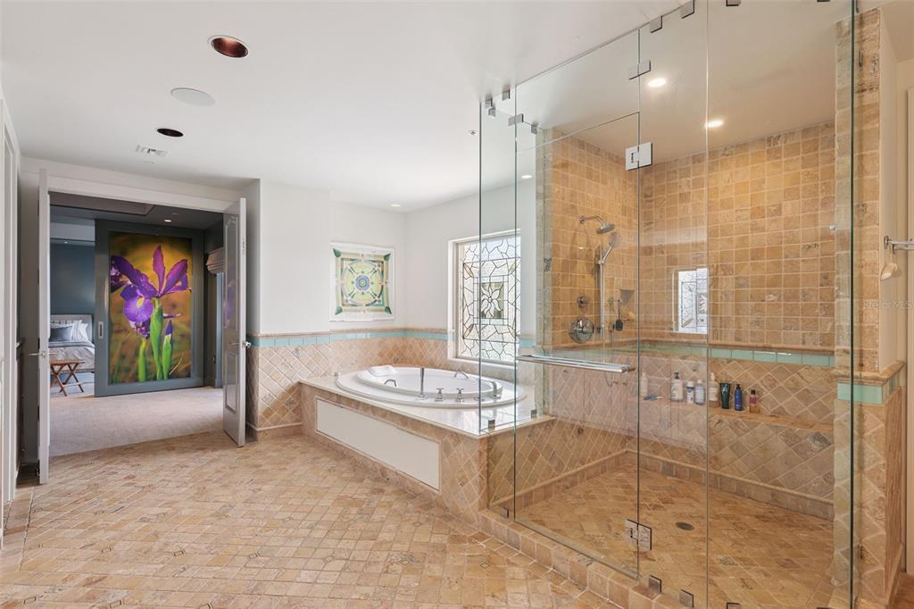 1111 Ritz Carlton Drive, Unit 1704 Sarasota, FL 34236 - Photo 48 of 53 a spacious bathroom with a tub sink and mirror