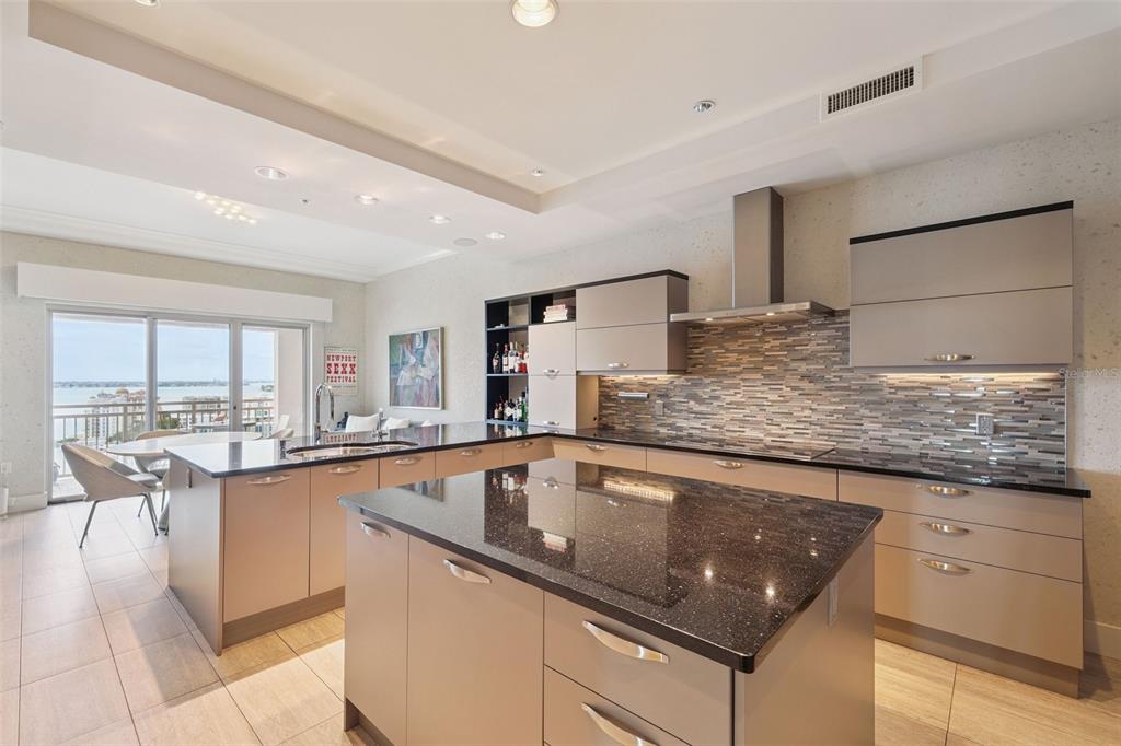 1111 Ritz Carlton Drive, Unit 1704 Sarasota, FL 34236 - Photo 5 of 53 a kitchen with stainless steel appliances granite countertop a sink stove and cabinets