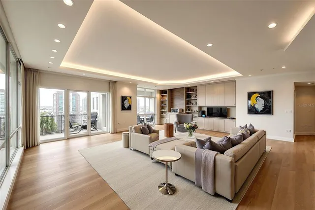 a living room with fireplace furniture and a large window