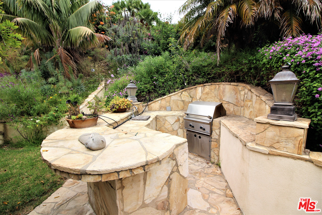 20219 Inland Lane Malibu, CA 90265 - Photo 11 of 28 a terrace with outdoor seating and kitchen view