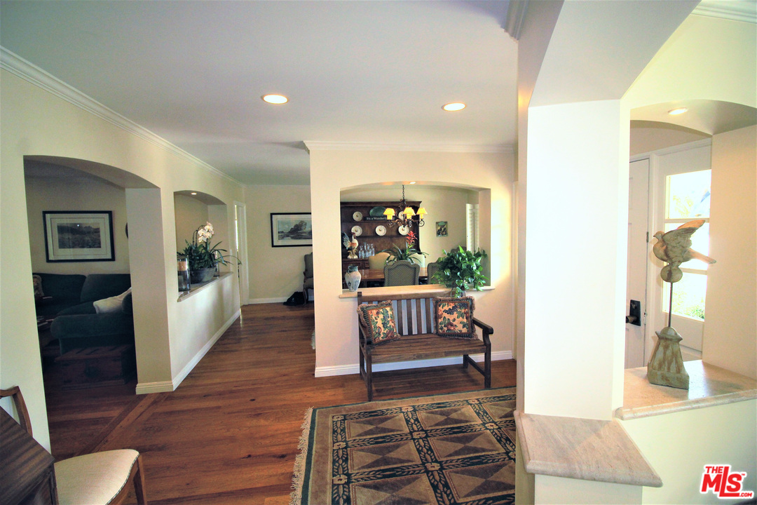 20219 Inland Lane Malibu, CA 90265 - Photo 13 of 28 a view of a hallway with wooden floor and dining room