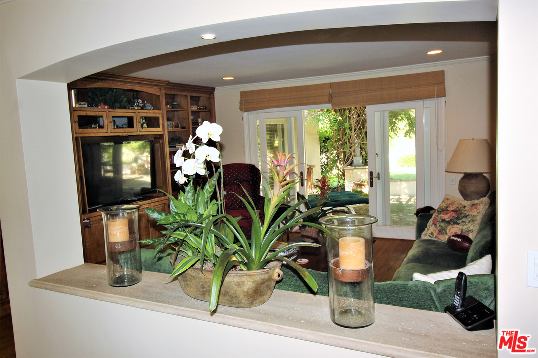 20219 Inland Lane Malibu, CA 90265 - Photo 14 of 28 a dining room with furniture a potted plant and a large window