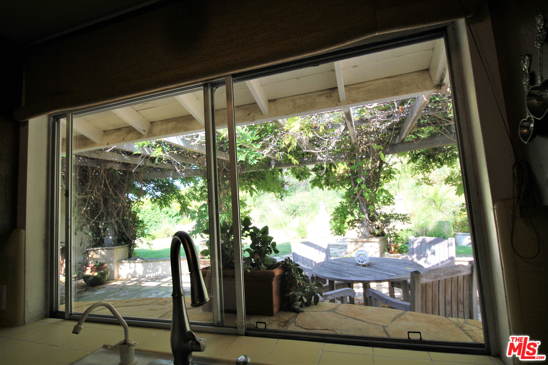 20219 Inland Lane Malibu, CA 90265 - Photo 22 of 28 a view of a porch with furniture and a yard