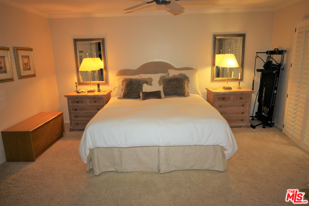 20219 Inland Lane Malibu, CA 90265 - Photo 23 of 28 a bedroom with a bed and a chandelier