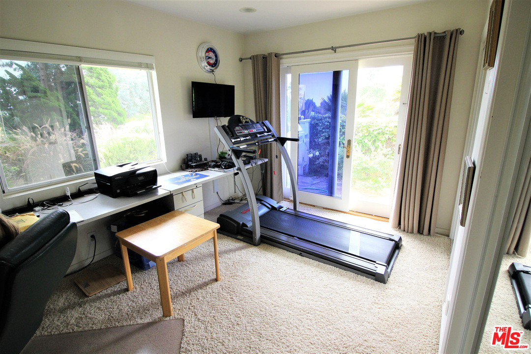20219 Inland Lane Malibu, CA 90265 - Photo 24 of 28 a living room with furniture and a flat screen tv