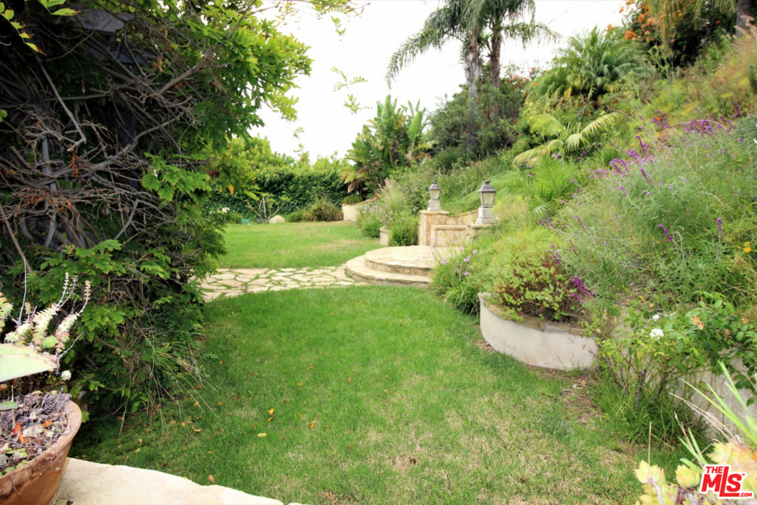 20219 Inland Lane Malibu, CA 90265 - Photo 26 of 28 a view of a table and chairs in the garden