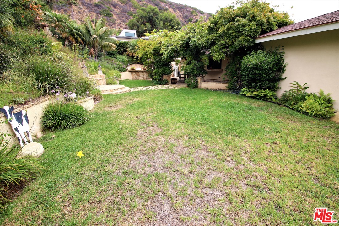 20219 Inland Lane Malibu, CA 90265 - Photo 27 of 28 a view of a tree in front of a house with a yard