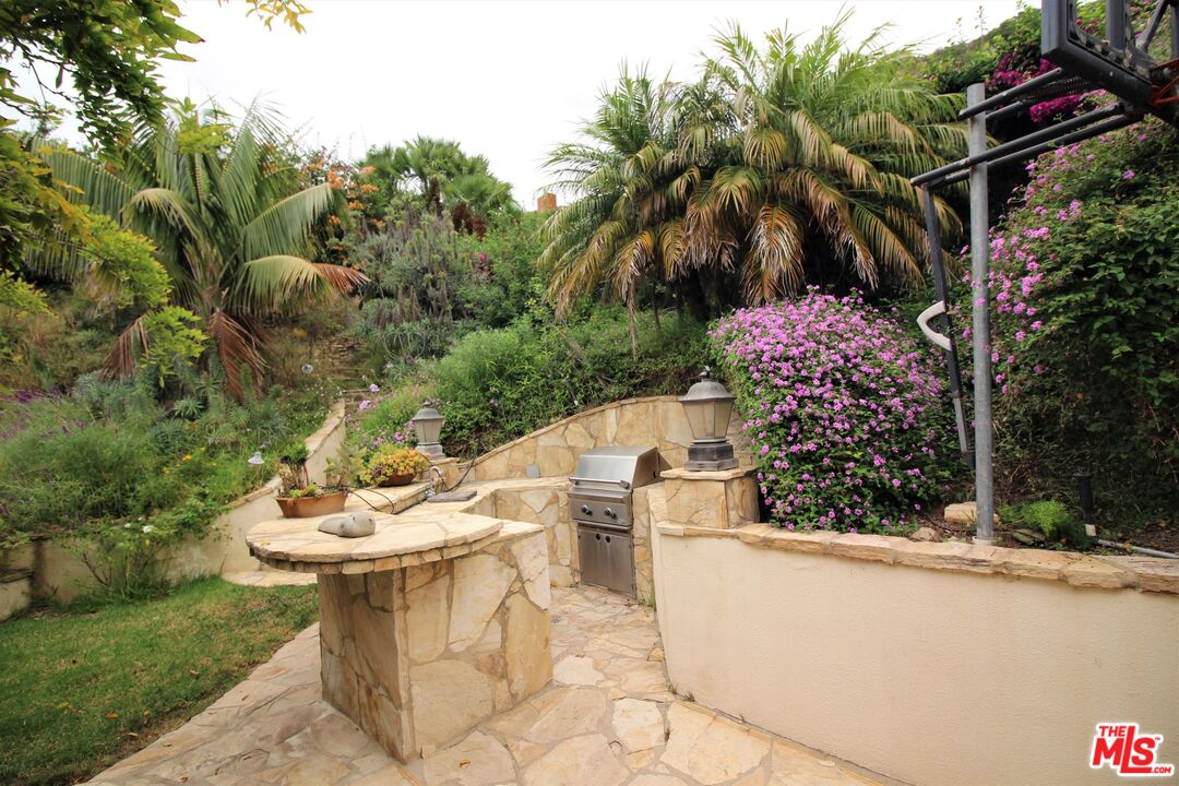 20219 Inland Lane Malibu, CA 90265 - Photo 7 of 28 a view of a white house with a sink and table in patio