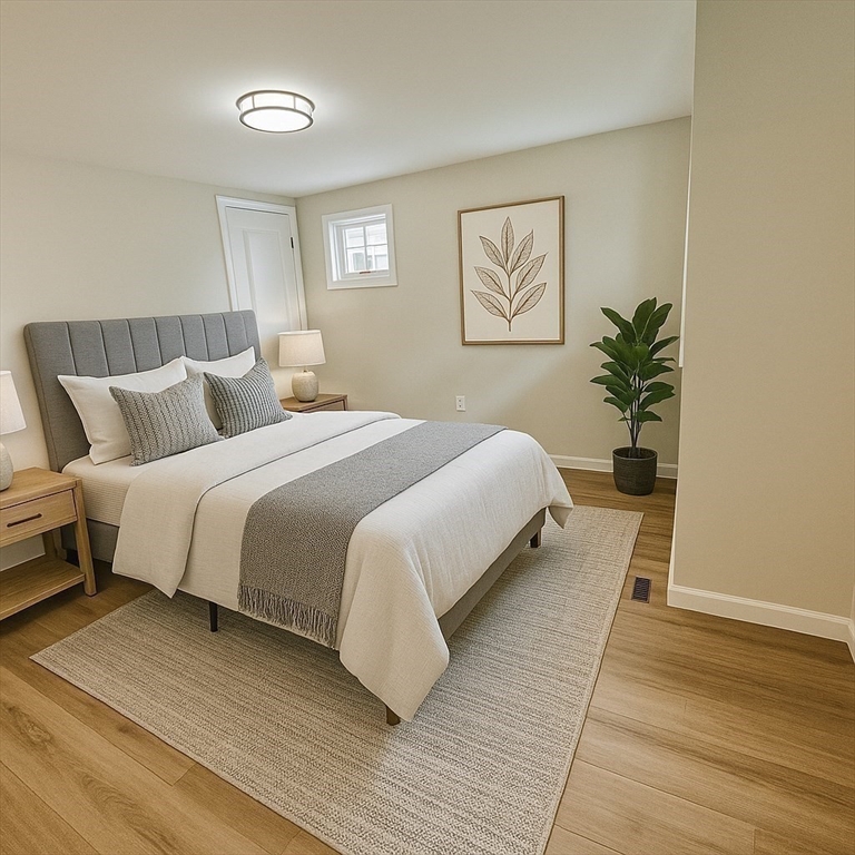 12 English Road Holbrook, MA 02343 - Photo 5 of 12 a bedroom with a large bed and a potted plant