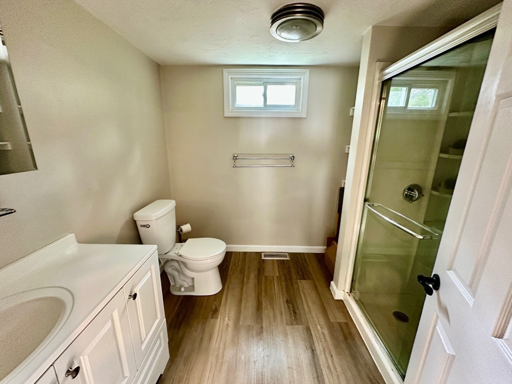 12 English Road Holbrook, MA 02343 - Photo 8 of 12 a bathroom with a sink a toilet and a mirror