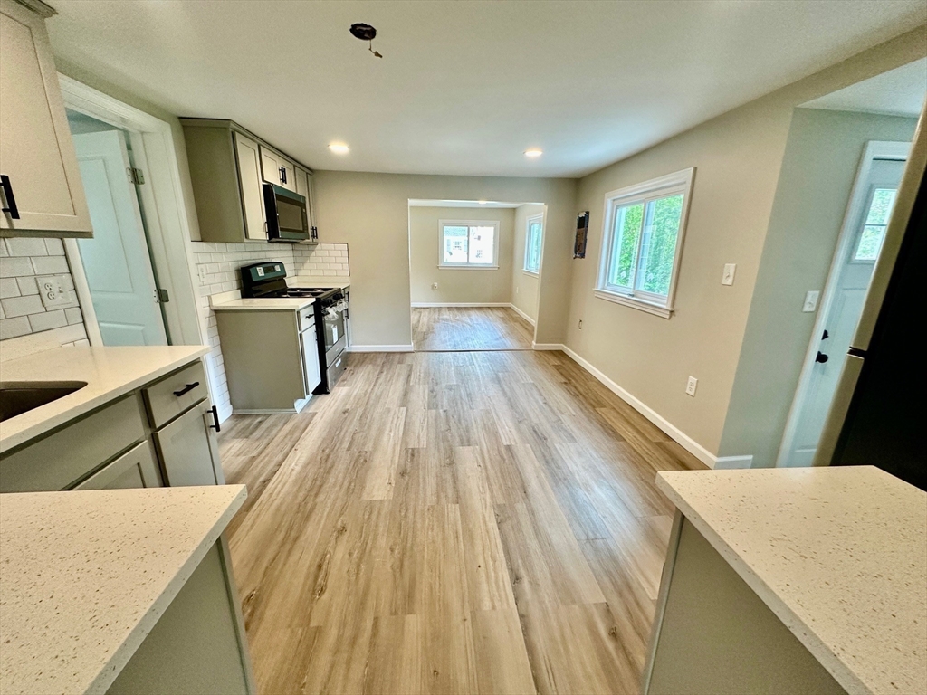 12 English Road Holbrook, MA 02343 - Photo 9 of 12 a view of a kitchen with wooden floor and electronic appliances