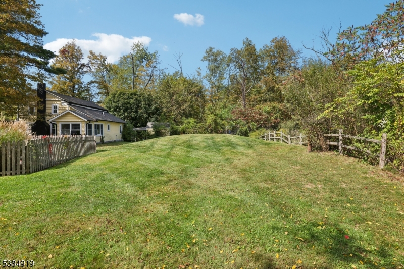 198 Libertyville Road Wantage, NJ 07461 - Photo 22 of 29 a yellow house with trees in front of it
