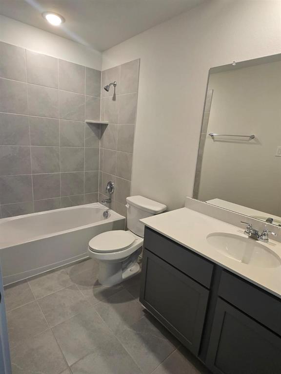 508 Weller Road McKinney, TX 75069 - Photo 12 of 16 Full bathroom featuring a white porcelain tub, a tiled shower surround, and a built-in shower shelf