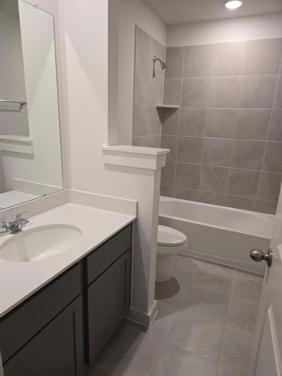 508 Weller Road McKinney, TX 75069 - Photo 13 of 16 Contemporary bathroom featuring a single vanity with dark cabinetry, a white countertop, and a chrome faucet