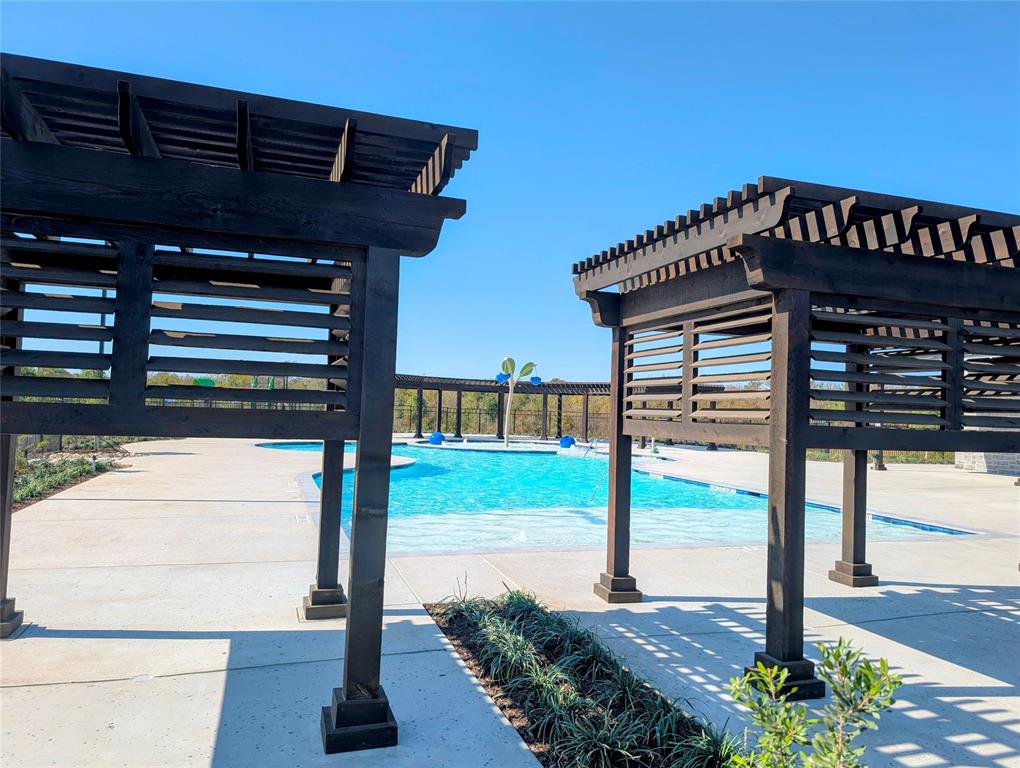 508 Weller Road McKinney, TX 75069 - Photo 16 of 16 Outdoor swimming pool with integrated sun shelf and dark wood pergolas