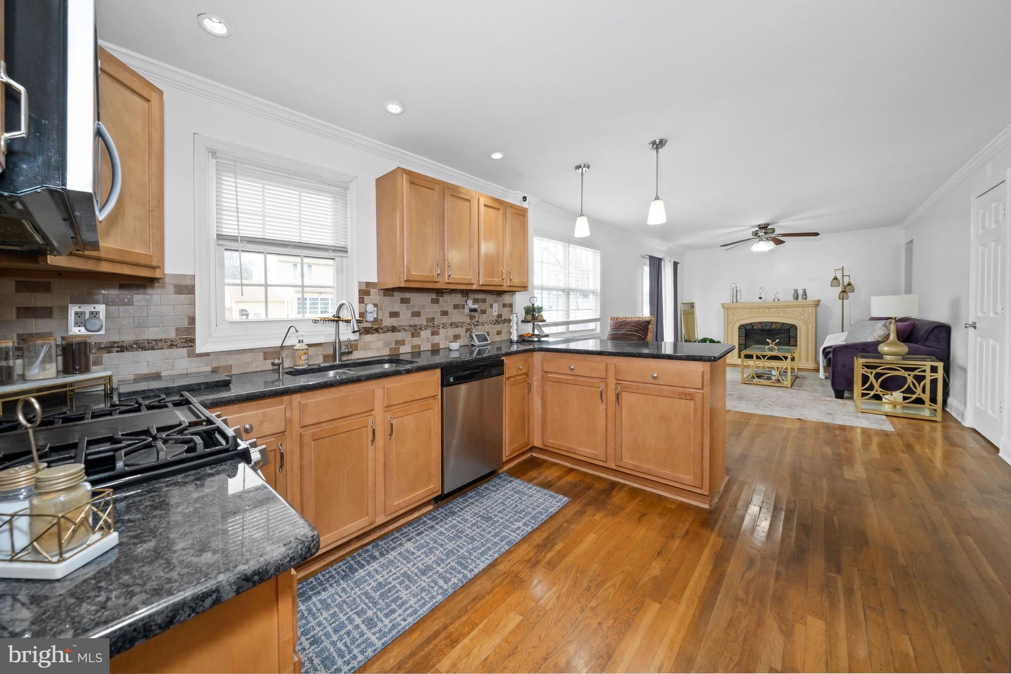 18 George Read Road New Castle, DE 19720 - Photo 17 of 40 a kitchen with stainless steel appliances granite countertop wooden cabinets a sink a stove a refrigerator and island