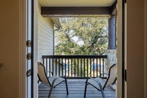a view of a balcony with wooden floor