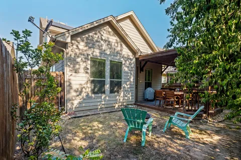 a view of a house with backyard and sitting area