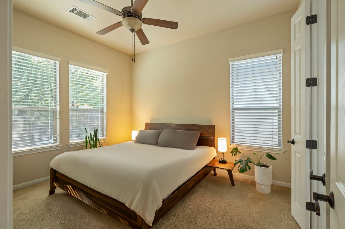 6717 Blarwood Drive Austin, TX 78745 - Photo 7 of 20 a bedroom with a bed and a chandelier