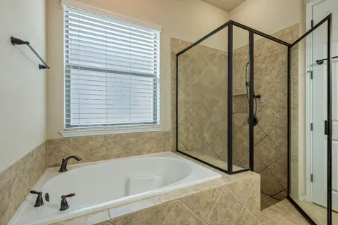 a bathroom with a tub and a shower