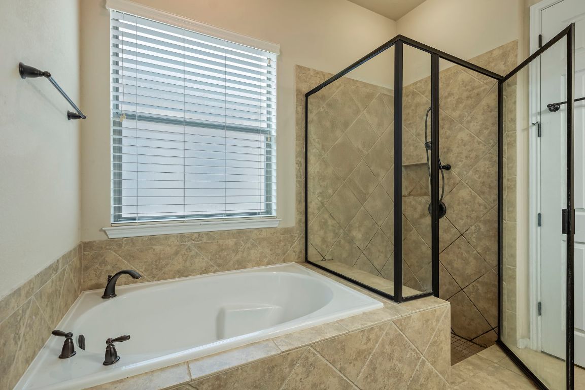 6717 Blarwood Drive Austin, TX 78745 - Photo 10 of 20 a bathroom with a tub and a shower
