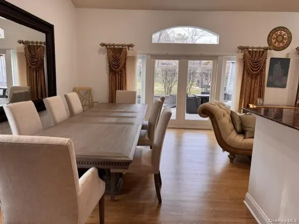 a kitchen with sink a refrigerator and chairs