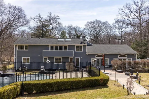 a view of a house with swimming pool and sitting area