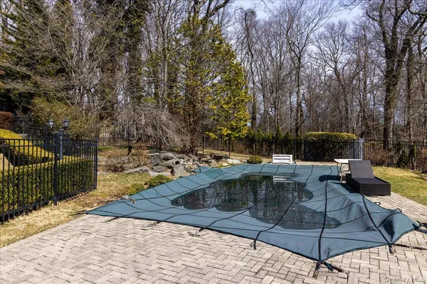 a swimming pool with trees in the background