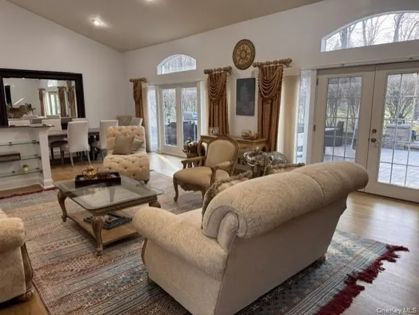 a living room with furniture fireplace and a large window