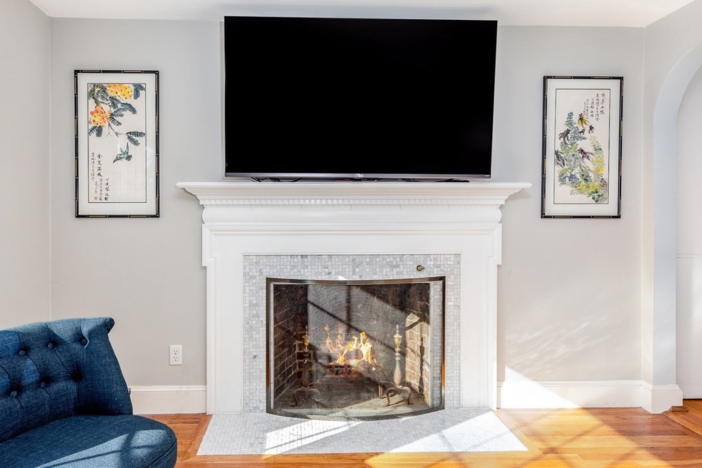 32 Norman Road Hamilton, MA 01982 - Photo 12 of 39 a living room with a fireplace and a flat screen tv