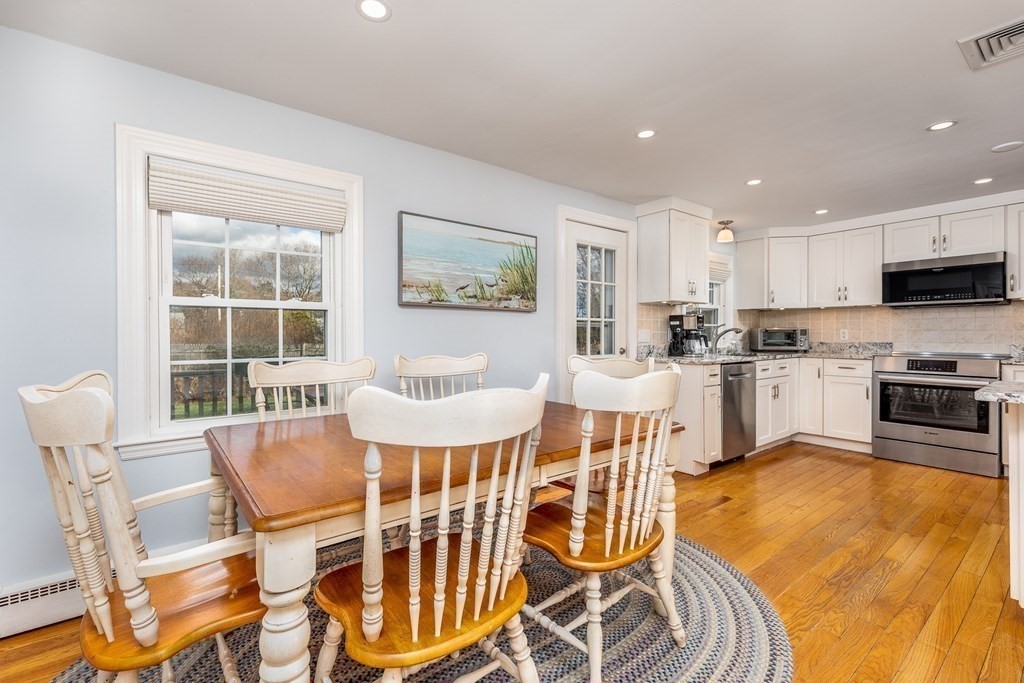 32 Norman Road Hamilton, MA 01982 - Photo 3 of 39 a dining room with furniture and a kitchen view