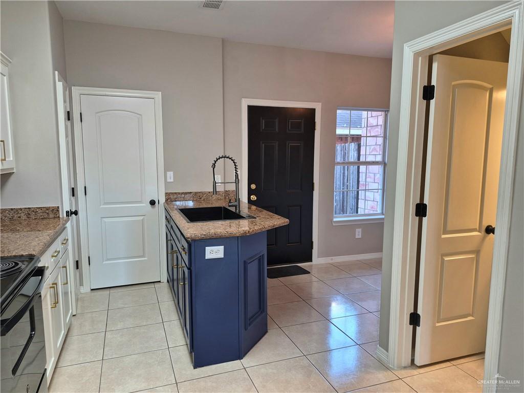 607 Jade Street, Unit 3 Edinburg, TX 78541 - Photo 11 of 19 a kitchen with granite countertop a sink and a stove