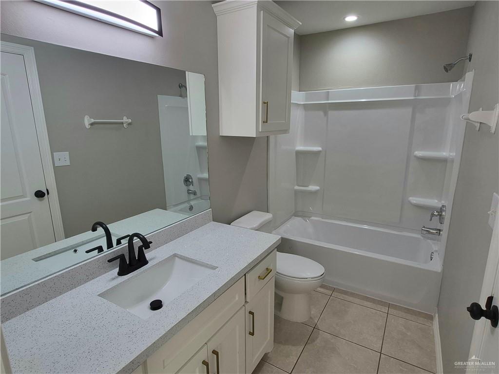 607 Jade Street, Unit 3 Edinburg, TX 78541 - Photo 16 of 19 a bathroom with a sink a toilet and shower
