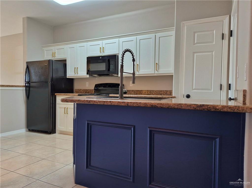 607 Jade Street, Unit 3 Edinburg, TX 78541 - Photo 8 of 19 a kitchen with stainless steel appliances granite countertop a refrigerator and a stove top oven