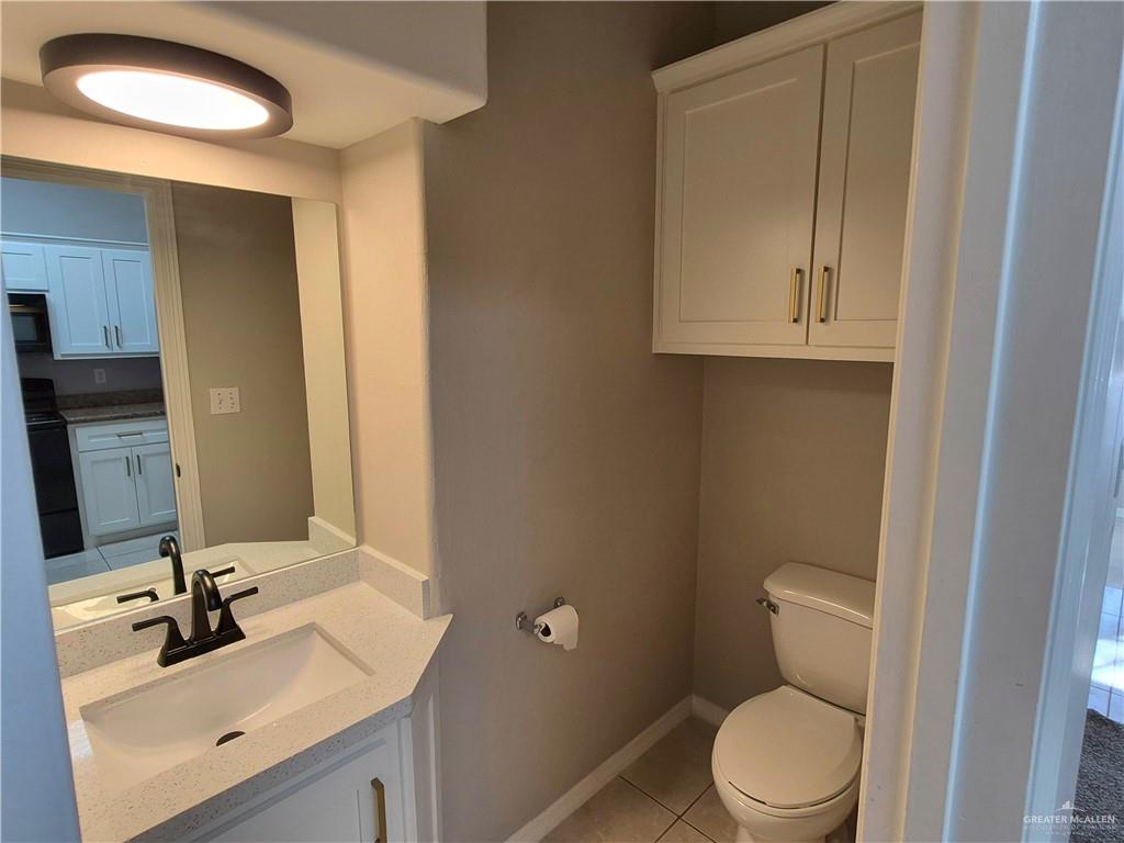 607 Jade Street, Unit 3 Edinburg, TX 78541 - Photo 10 of 19 a bathroom with a toilet sink and mirror