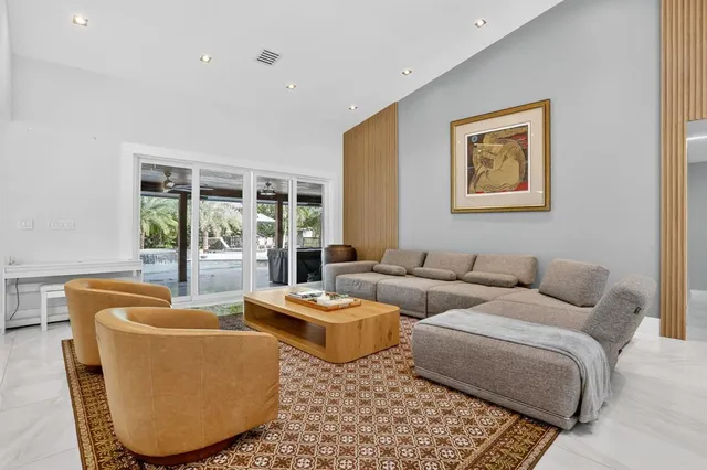 a view of patio with chairs and table under an umbrella