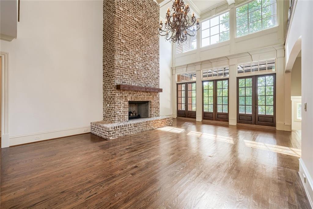7965 Robin Road Cumming, GA 30041 - Photo 12 of 64 an empty room with wooden floor and fireplace