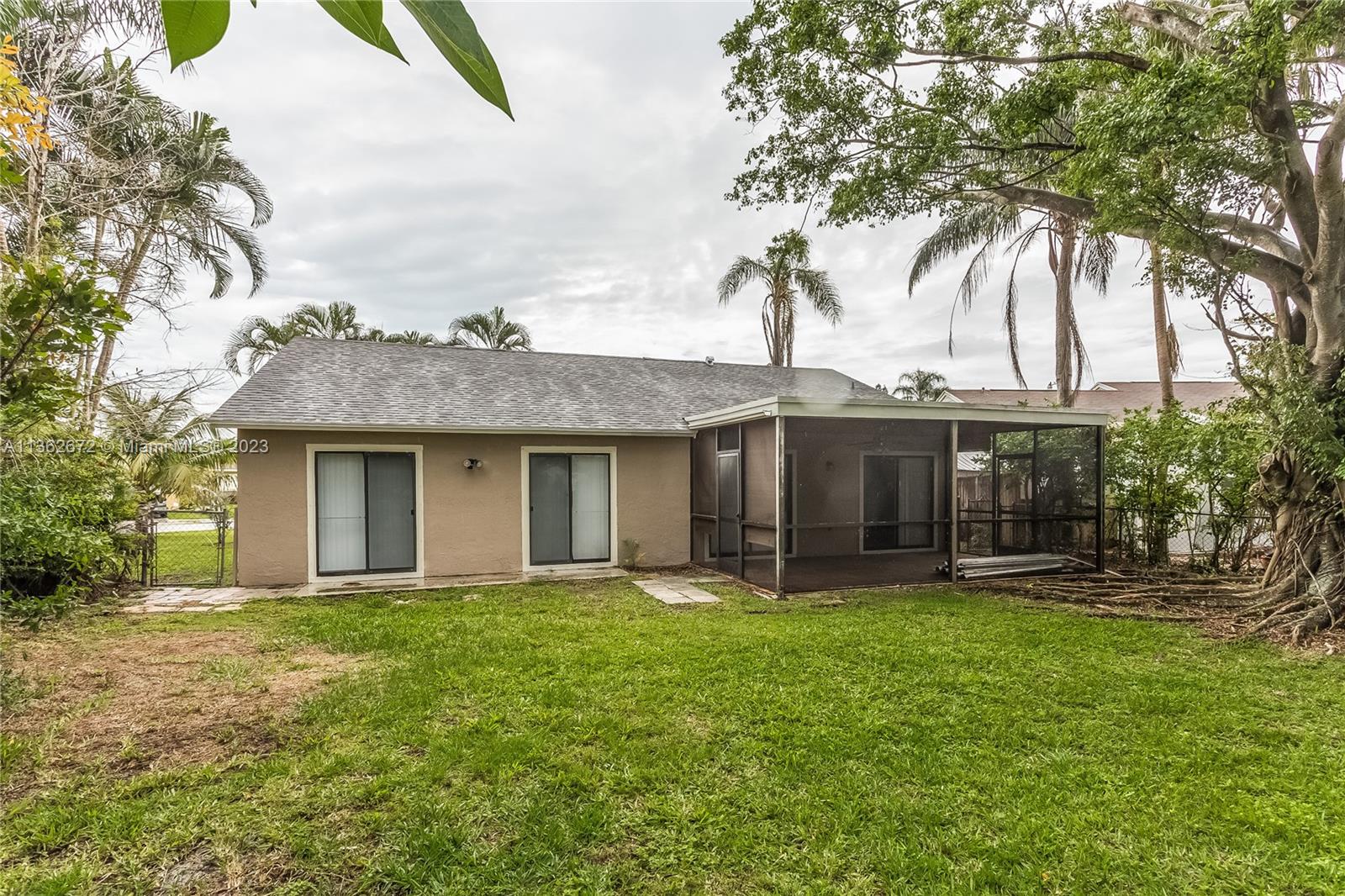 134 Timberline Drive Jupiter, FL 33458 - Photo 14 of 15 a front view of house with yard and trees in the background