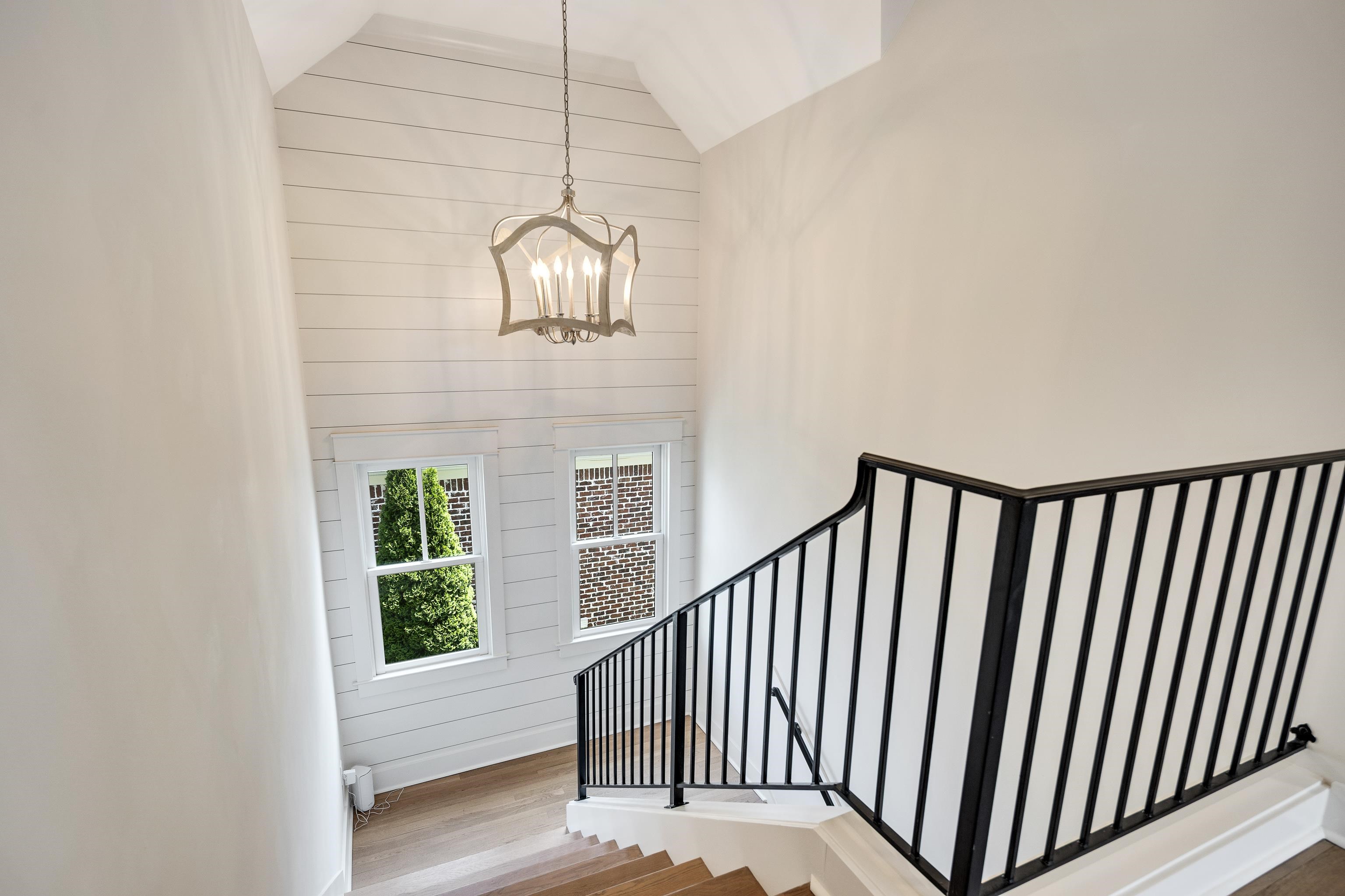 100 Sunflower View Road Piperton, TN 38017 - Photo 25 of 29 Grand staircase featuring wood treads, black iron balusters, and a vaulted shiplap ceiling