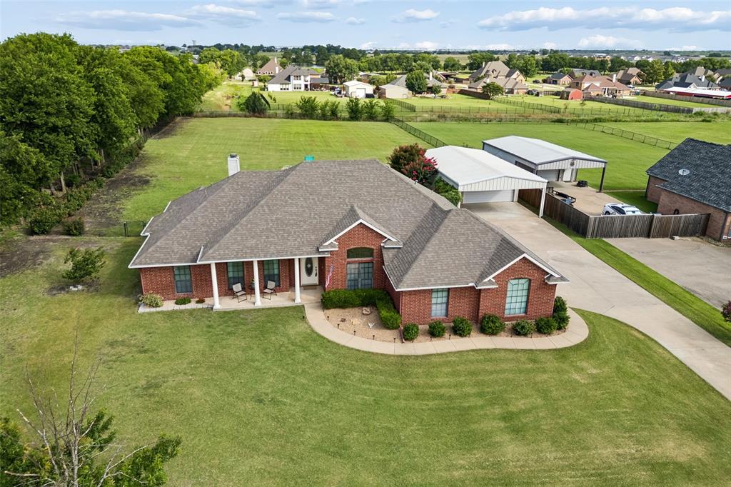 11211 Emerald Ranch Lane Forney, TX 75126 - Photo 10 of 35 Brick exterior residence with a covered front porch, an extensive driveway, and a detached carport