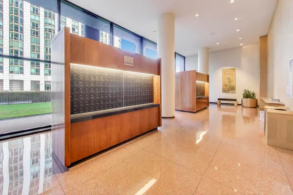 a kitchen with granite countertop white cabinets and stainless steel appliances