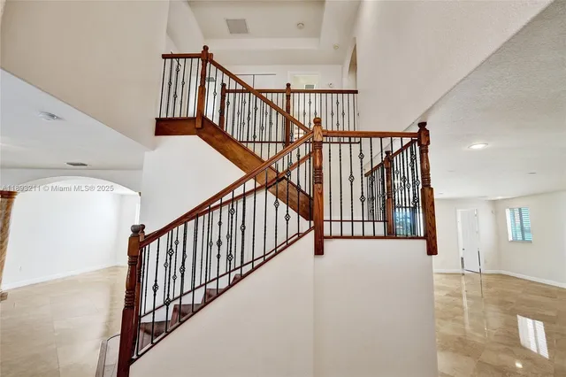 a view of staircase with wooden floor and a rug