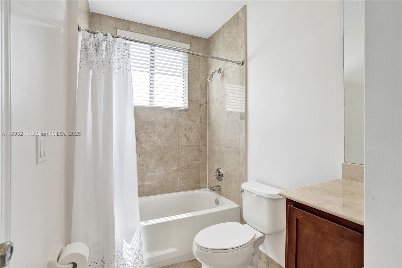7722 Southwest 188th Terrace Cutler Bay, FL 33157 - Photo 27 of 89 a bathroom with a granite countertop bathtub shower sink vanity and toilet