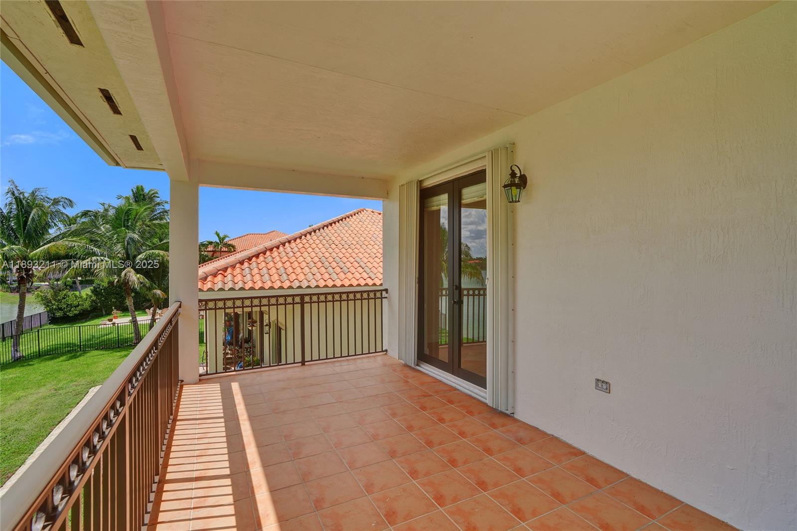7722 Southwest 188th Terrace Cutler Bay, FL 33157 - Photo 39 of 89 a view of balcony with a floor to ceiling window and wooden fence