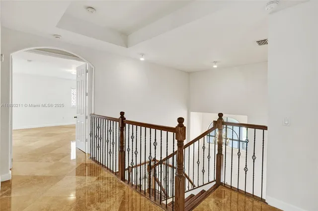 a room with lots of table chair and a ceiling fan