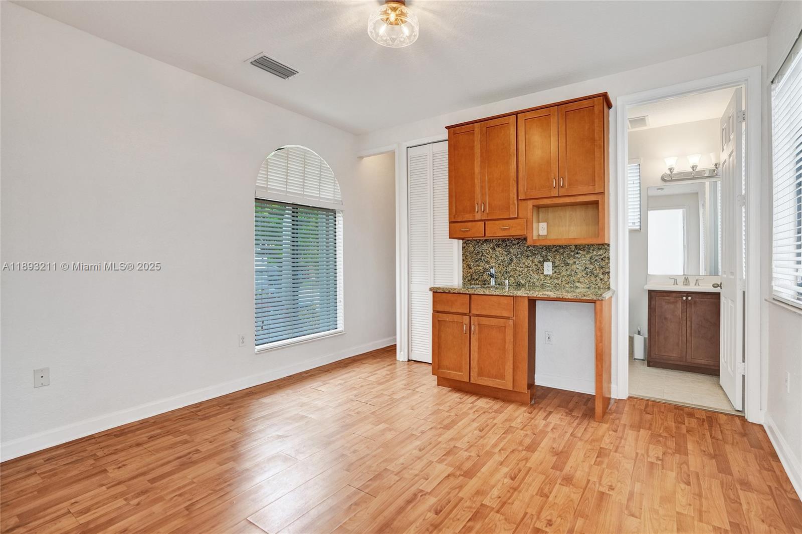 7722 Southwest 188th Terrace Cutler Bay, FL 33157 - Photo 69 of 89 a view of an empty room with window and wooden floor